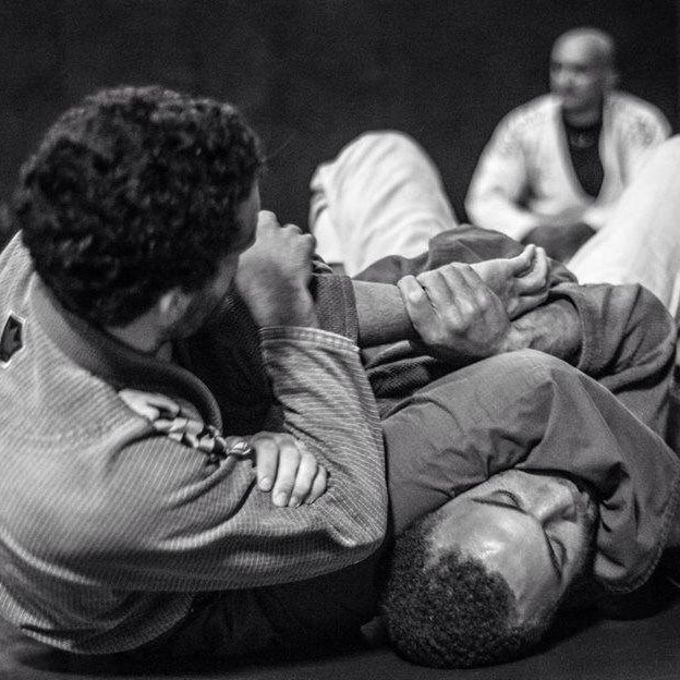 Kirk locks up a armbar while his opponent defends fro the bottom